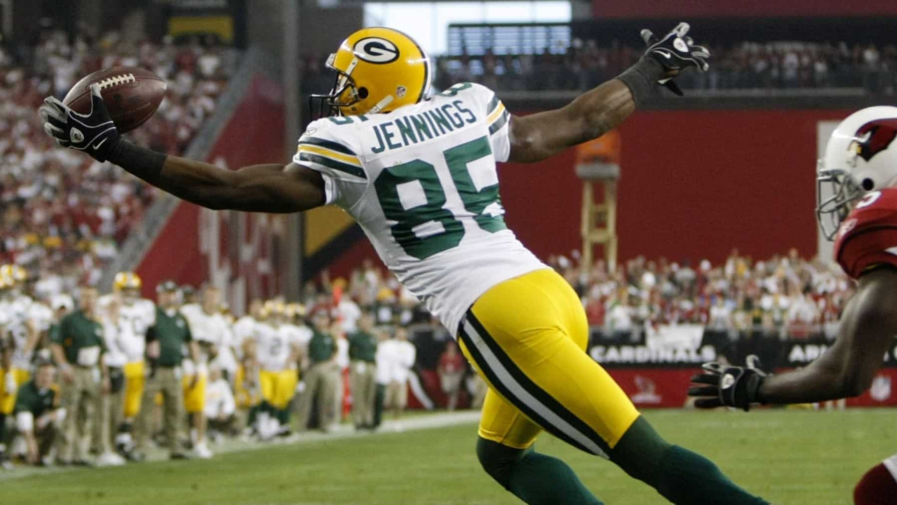 Green Bay Packers wide receiver Greg Jennings is hit by Oakland